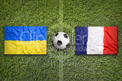Ukraine vs. France flags on soccer field