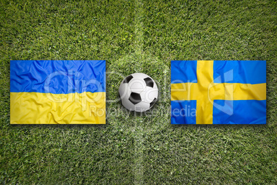 Ukraine vs. Sweden flags on soccer field