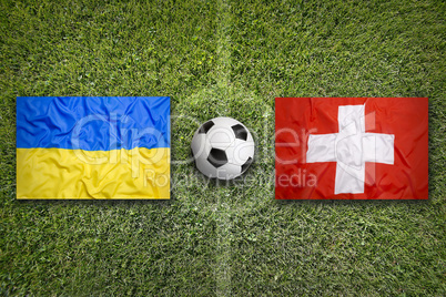 Ukraine vs. Switzerland flags on soccer field