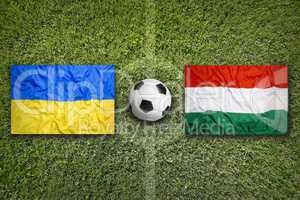 Ukraine vs. Hungary flags on soccer field