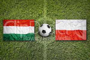 Hungary vs. Poland flags on soccer field