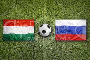 Hungary vs. Russia flags on soccer field