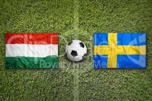 Hungary vs. Sweden flags on soccer field