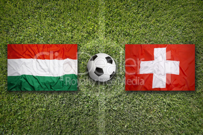 Hungary vs. Switzerland flags on soccer field