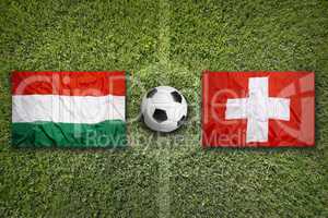 Hungary vs. Switzerland flags on soccer field
