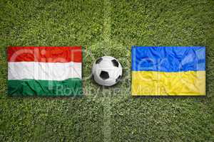 Hungary vs. Ukraine flags on soccer field