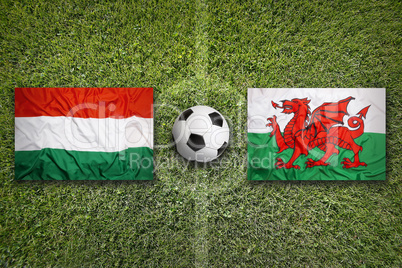 Hungary vs. Wales flags on soccer field