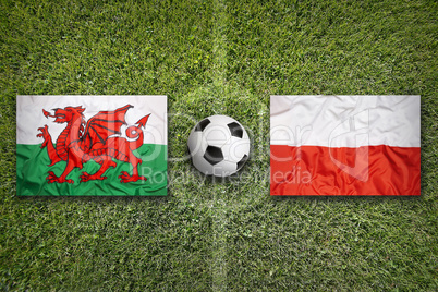 Wales vs. Poland flags on soccer field