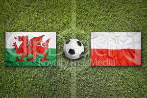 Wales vs. Poland flags on soccer field