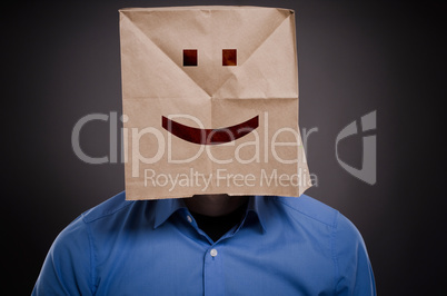 Businessman with a smiling face on a paper bag