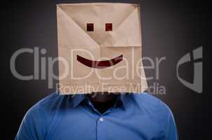 Businessman with a smiling face on a paper bag