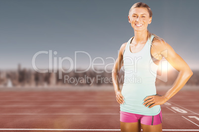 Composite image of fit woman posing and smiling