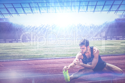 Composite image of portrait of sportsman stretching his muscle