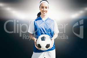 Composite image of woman holding soccer ball