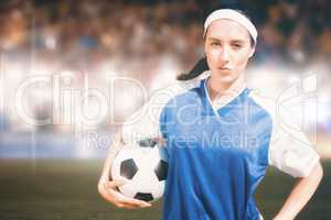 Composite image of woman football player posing with football on