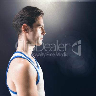 Composite image of side view of male athlete on black background