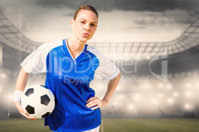 Composite image of portrait of woman football player is posing