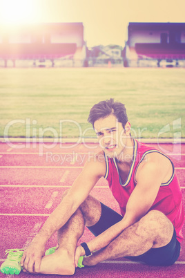 Composite image of portrait of male athlete with foot pain on wh