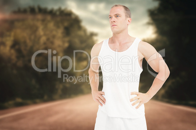 Composite image of confident athlete with hand on hip Composite image of confident athlete with hand on hip