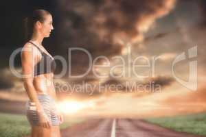 Composite image of profile view of sportswoman standing on a whi