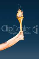 Composite image of sporty woman holding olympic torch