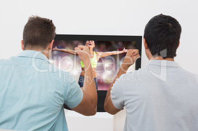 Composite image of fit woman celebrating victory with arms stret