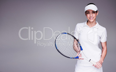 Composite image of female athlete posing with tennis racket Composite image of female athlete posing with tennis racket