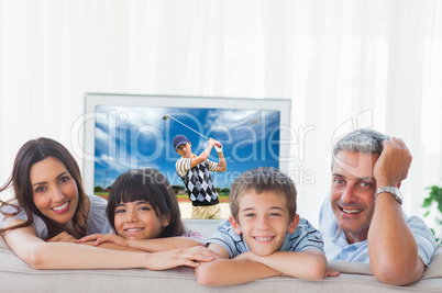 Composite image of family in sitting room smiling at camera
