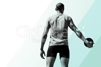 Composite image of rear view of sportsman holding a discus on a