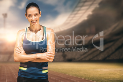 Composite image of sportswoman posing and smiling on a white bac