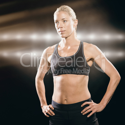 Composite image of female athlete standing with hand on hip