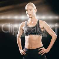 Composite image of female athlete standing with hand on hip