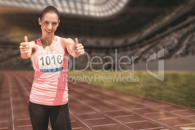 Composite image of athlete woman smiling with thumbs up