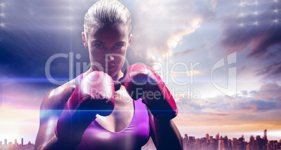 Composite image of portrait of woman fighter with gloves