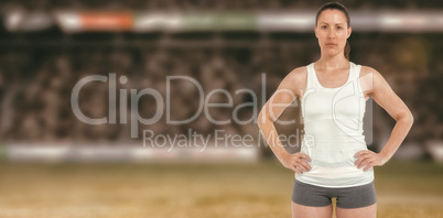 Composite image of portrait of female athlete standing with hand Composite image of portrait of female athlete standing with hand