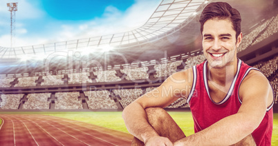 Composite image of portrait of happy athlete sitting on white ba