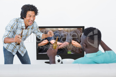 Composite image of soccer fans watching tv