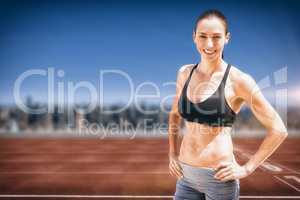 Composite image of portrait of sportswoman is posing and smiling