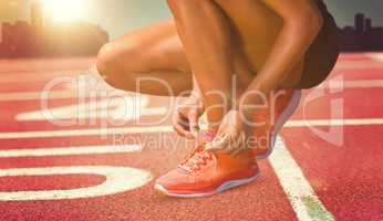 Composite image of close up of sportswoman is lacing shoes