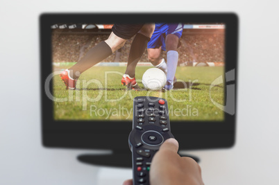 Composite image of hand holding remote and changing channel
