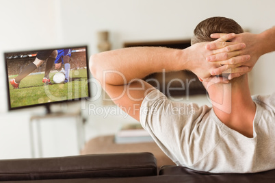 Composite image of man relaxing on his couch