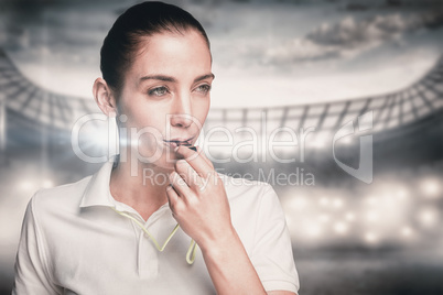Composite image of female athlete blowing a whistle