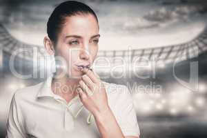 Composite image of female athlete blowing a whistle