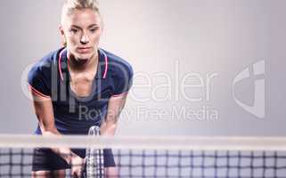 Composite image of tennis player playing tennis with a racket