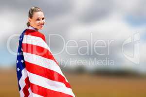 Composite image of portrait of happy american sportswoman posing