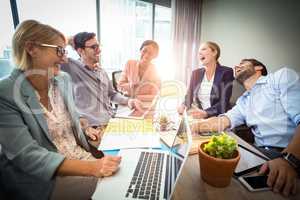 Business people laughing during a meeting