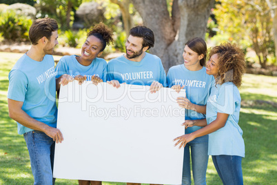 Group of volunteer holding blank sheet