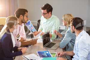 Business people discussing over graph during a meeting