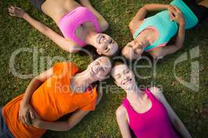 Beautiful young women lying on grass