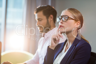 Thoughtful businesswoman with hand on chin